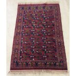 A small vintage rug of blue and red colouration.