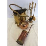 A brass coal bucket and companions set together with a copper kettle and milk measure.