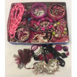 A tin containing a large quantity of costume jewellery.