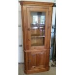 A solid pine corner cabinet with glazed top.