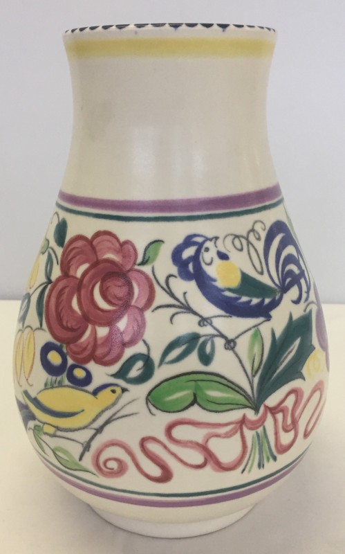 A large Poole pottery vase with floral design and signature "blue bird".