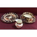A Royal Crown Derby Imari trio, pattern 2451 together with a small cream jug pattern 2649.