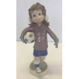 A boxed Lladro figurine of Sport Billy playing football (girl).