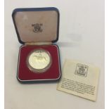 A boxed Silver Jubilee silver crown proof coin.