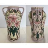 A Moorcroft 2 handled vase with pink flower design with green interior.