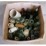 A box of assorted vintage glass and ceramic bottles and jars.