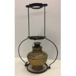 A vintage suspended oil lamp.