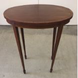 An oval mahogany wine table.