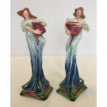A pair of Art Nouveau figural candlesticks of water nymphs marked with intertwined T.G. initials.