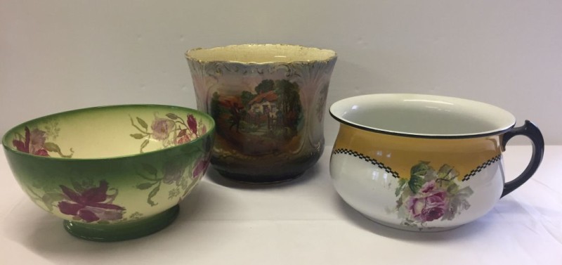 An early 20th century jardinière, a German bowl with flower decoration and a chamber pot.