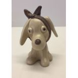 A ceramic Sylvac 'toothache' dog figurine.