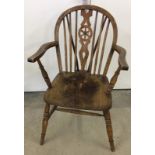 An antique Windsor chair marked AH.
