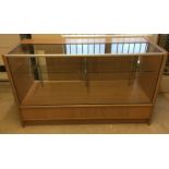 A large modern pine effect & glass shop counter.