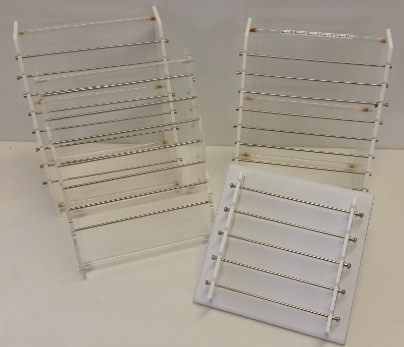 4 shop display jewellery bead stands. 3 plastic and 1 white, leather effect.