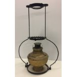 A vintage suspended oil lamp