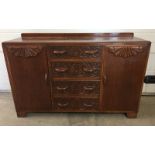 An Art Deco light wood carved fronted sideboard.