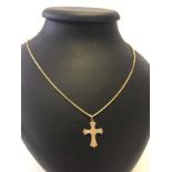 A 9ct gold engraved cross pendant on a 9ct gold 22" chain.