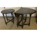 A small dark wood drop leaf table with barley twist legs.