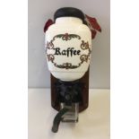 Vintage Dutch wall mounted coffee grinder with ceramic coffee bean container.