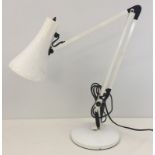 A white modern angle poise lamp.