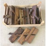 A box of vintage wooden box planes.