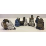 4 ceramic figures of Chinese men.