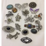 A small quantity of costume jewellery brooches in silver tones to include Miracle.