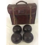 A set of lawn bowls in leather bag.