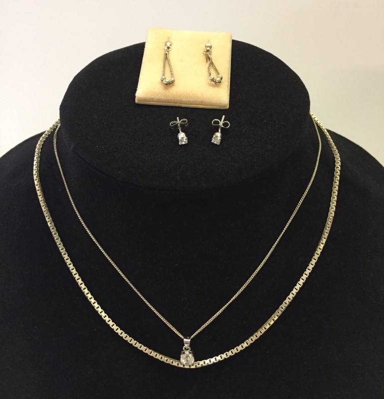 A silver chain with crystal pendant & matching earrings.