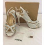 A Pair of brand new Christian Louboutin Paris peep toe sling back shoes.