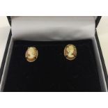 Pair of 9ct gold earrings set with cameos.