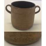 A French 2 handled pottery cup.