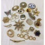 A small collection of vintage gold tone brooches. Some stone set.