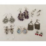 7 pairs of silver earrings of various designs.