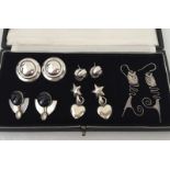 5 pairs of chunky silver earrings.