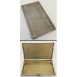 A solid silver cigarette case.