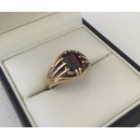 A gents 9ct gold and garnet signet ring.