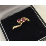 A vintage 18ct gold dress ring set with 2 rubies.