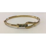 9ct gold bangle set with green and clear crystals. With clip over safety clasp.