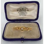 A Victorian 15ct gold bar brooch set with central diamond.