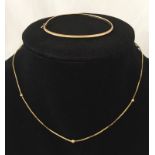 A 40cm 9ct gold box chain necklace decorated with 7 balls.