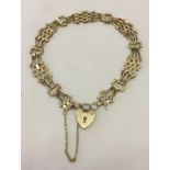 9ct gold gate bracelet with heart shaped padlock clasp and safety chain.