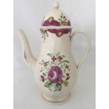 A circa 1790 cream ware coffee pot with purple flower decoration.