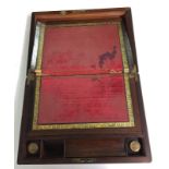 A Victorian writing box with mother of pearl inlay to top and lock and original ink bottles.