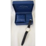 A boxed 9ct gold cased gents Rotary wristwatch with black leather strap.