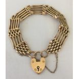 A vintage 15ct gold five bar gate bracelet with heart padlock.