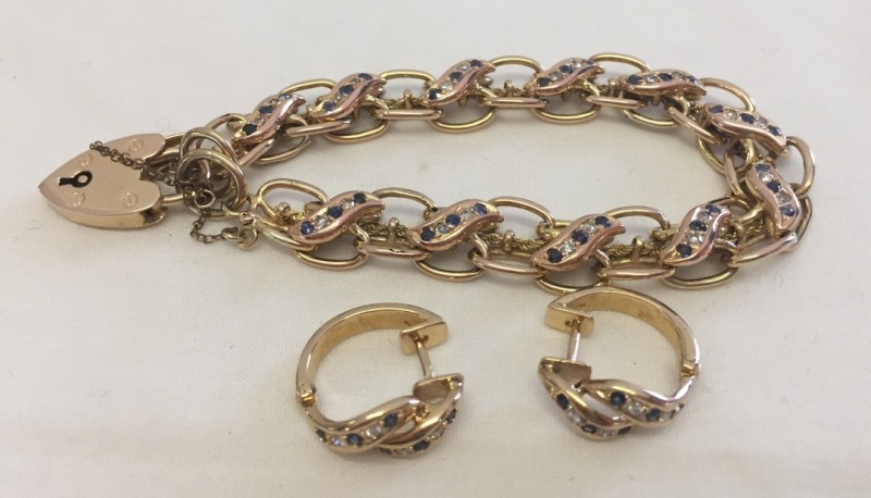 A 9ct gold double link bracelet with heart shaped lock clasp.