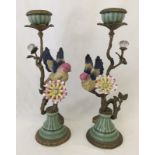 A pair of bird and flower ceramic and metal candlesticks