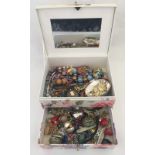 A floral jewellery box together with contents to include brooches, beads, earrings and watches.
