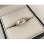 A 9ct white gold wedding band.